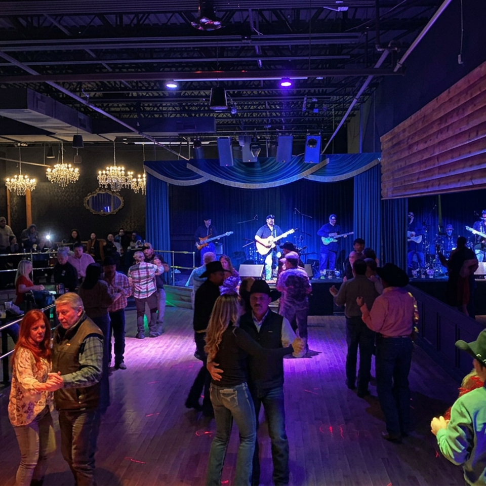 Live band performs on a stage while couples dance in a restaurant with chandeliers and blue-purple lighting.